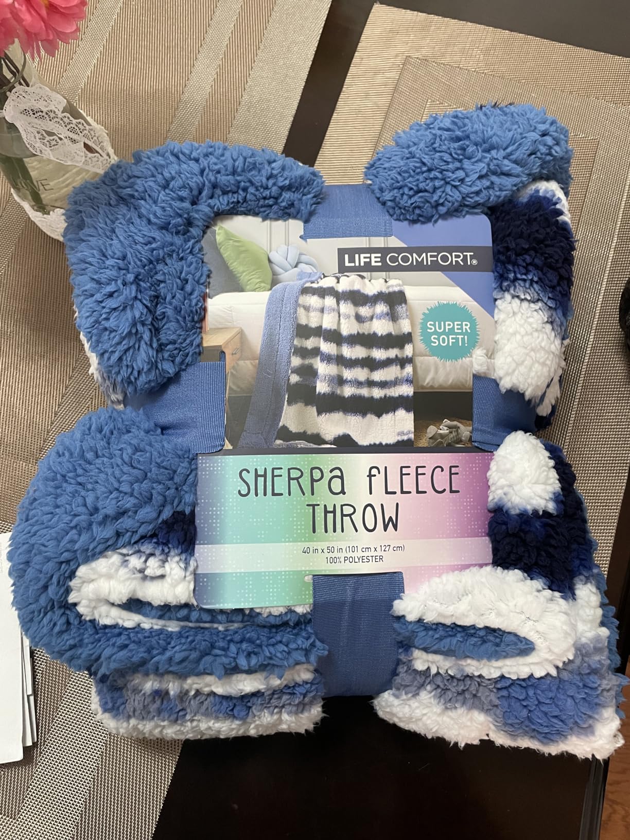 A folded Life Comfort Sherpa Fleece Throw in blue and white, still banded in its packaging, marked 40 in x 50 in and 100% polyester